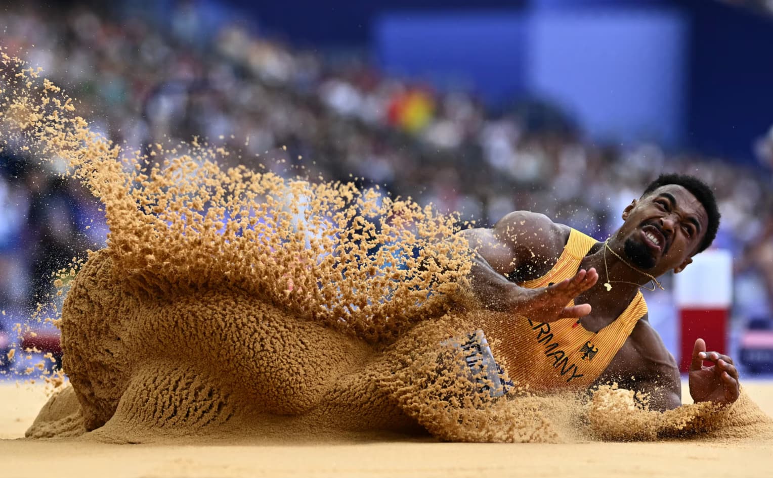 German track and field athlete Leo Neugebauer lands during the long jump.